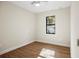 Well-lit bedroom with wood-look tile flooring and a window at 4497 N Salford Blvd, North Port, FL 34286