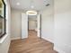 Light-filled dining room with wood-look floors and view to kitchen at 4497 N Salford Blvd, North Port, FL 34286