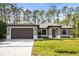 New construction home with a paved driveway and beautifully manicured lawn at 4497 N Salford Blvd, North Port, FL 34286