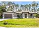 Newly constructed single-Gathering home with a 2-car garage and lush landscaping at 4497 N Salford Blvd, North Port, FL 34286