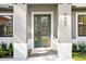 Modern front entry with a green door and paver walkway at 4497 N Salford Blvd, North Port, FL 34286