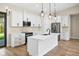 Modern kitchen with white shaker cabinets, quartz countertops, and stainless steel appliances at 4497 N Salford Blvd, North Port, FL 34286
