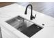 High-end kitchen sink with modern faucet and cutting board at 4497 N Salford Blvd, North Port, FL 34286