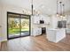 Modern kitchen with white cabinets, island, and stainless steel appliances at 4497 N Salford Blvd, North Port, FL 34286