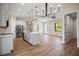Open concept kitchen and living area with white cabinets and a large island at 4497 N Salford Blvd, North Port, FL 34286