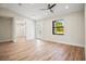 Spacious living room featuring wood-look floors and a ceiling fan at 4497 N Salford Blvd, North Port, FL 34286