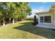 Backyard view showcasing a lawn, trees, and patio at 4534 Fern Dr, Bradenton, FL 34208