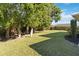 Landscaped backyard featuring a grassy area and trees at 4534 Fern Dr, Bradenton, FL 34208