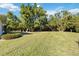 Large backyard with grassy area and tree line at 4534 Fern Dr, Bradenton, FL 34208