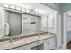 Double vanity bathroom with granite countertop and large mirror at 4534 Fern Dr, Bradenton, FL 34208
