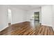Bright bedroom with wood-look floors and sliding glass doors to a screened porch at 4534 Fern Dr, Bradenton, FL 34208