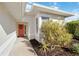 Inviting front entry with coral door and landscaping at 4534 Fern Dr, Bradenton, FL 34208