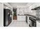 White kitchen with black appliances and patterned backsplash at 4534 Fern Dr, Bradenton, FL 34208