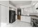 Bright kitchen with white cabinets, black appliances, and tile floor at 4534 Fern Dr, Bradenton, FL 34208