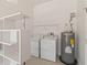 Convenient laundry room with washer, dryer, and shelving at 4534 Fern Dr, Bradenton, FL 34208