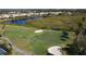 Golf course with players and a lake at 4617 Samoset Dr, Sarasota, FL 34241