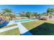 Inviting backyard oasis featuring a refreshing pool, ample lawn space, and a wooden fence at 511 E 65Th Ave, Bradenton, FL 34203