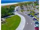 Aerial view of parking lot, beach, and park with lush green areas at 5353 Shadow Lawn Dr, Sarasota, FL 34242