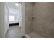 Clean bathroom with a walk-in shower and gray tile at 5469 Fair Oaks Street St # 5C, Bradenton, FL 34203