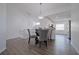 Dining area with a glass table and gray chairs, overlooking the kitchen at 5469 Fair Oaks Street St # 5C, Bradenton, FL 34203