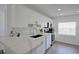 Modern kitchen with white cabinets and marble countertops at 5469 Fair Oaks Street St # 5C, Bradenton, FL 34203