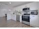 Modern kitchen featuring stainless steel appliances and white cabinets at 5469 Fair Oaks Street St # 5C, Bradenton, FL 34203