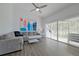 Bright living room with gray sectional sofa, large art piece, and sliding glass doors to balcony at 5469 Fair Oaks Street St # 5C, Bradenton, FL 34203