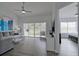 Spacious living room with sliding glass doors to balcony at 5469 Fair Oaks Street St # 5C, Bradenton, FL 34203