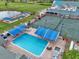Community pool with lounge chairs, tennis courts nearby at 5469 Fair Oaks Street St # 5C, Bradenton, FL 34203