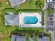 Community pool with lounge chairs and umbrellas at 5469 Fair Oaks Street St # 5C, Bradenton, FL 34203