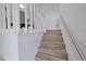 Modern staircase with wood-look flooring and metal railing at 5469 Fair Oaks Street St # 5C, Bradenton, FL 34203