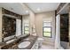 Bathroom with a bathtub, shower, and dark marble countertop at 5575 Beneva Woods Cir, Sarasota, FL 34233