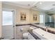 Clean bathroom with a modern vanity, shower, and tiled floors at 5575 Beneva Woods Cir, Sarasota, FL 34233