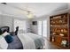 Bright bedroom with a queen bed, built-in shelving, and access to backyard at 5575 Beneva Woods Cir, Sarasota, FL 34233