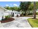 Landscaped entryway with curved driveway at 5575 Beneva Woods Cir, Sarasota, FL 34233