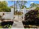 Attractive front entry with gate and pond at 5575 Beneva Woods Cir, Sarasota, FL 34233