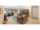 Living room with brown couches, and access to the pool at 5575 Beneva Woods Cir, Sarasota, FL 34233