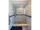 Large walk-in shower with pebble floor and glass enclosure at 5575 Beneva Woods Cir, Sarasota, FL 34233