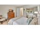 Well-lit bedroom with a queen bed and dresser at 5944 Welcome Rd # H25, Bradenton, FL 34207