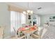 Dining area with white table and chairs, and decorative chandelier at 6238 7Th W Ave # 6238, Bradenton, FL 34209