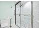 Bathroom with marble shower, white vanity and toilet at 6401 Pelican Dr # 80A, Bradenton, FL 34210