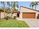 Updated condo exterior with a 1 car garage and lush landscaping at 6401 Pelican Dr # 80A, Bradenton, FL 34210