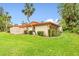 Well-maintained exterior with a large grassy area and tropical landscaping at 6401 Pelican Dr # 80A, Bradenton, FL 34210