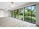 Living room with sliding glass doors, hardwood flooring and access to backyard at 6401 Pelican Dr # 80A, Bradenton, FL 34210