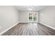 Bright living room featuring wood-look floors and sliding glass doors at 6401 Pelican Dr # 80A, Bradenton, FL 34210