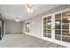 Sunroom with white french doors, ceiling fans and light brown vinyl flooring at 6401 Pelican Dr # 80A, Bradenton, FL 34210