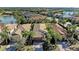 Aerial view of houses in a community with palm trees and a lake at 6739 Haverhill Ct, Lakewood Ranch, FL 34202