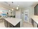 Kitchen with island, stainless steel appliances, and dark cabinets at 6739 Haverhill Ct, Lakewood Ranch, FL 34202