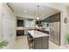 Modern kitchen with dark cabinetry, stainless steel appliances, and an island at 6739 Haverhill Ct, Lakewood Ranch, FL 34202