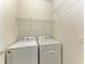 Laundry room with washer, dryer, and overhead shelving at 6739 Haverhill Ct, Lakewood Ranch, FL 34202